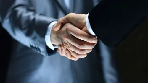 Consultant and manager shake hands and agree to WCB Consulting
